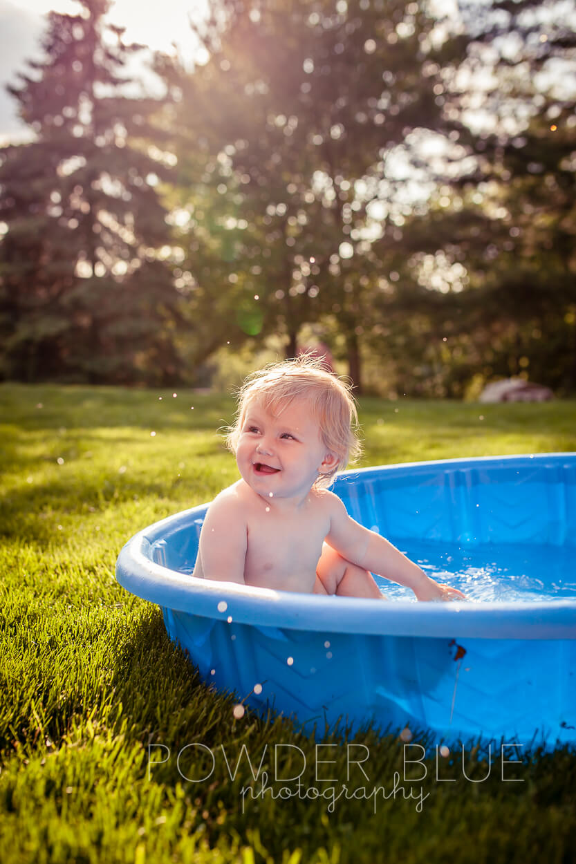 Toddler splashing in baby pool pittsburgh baby photographer